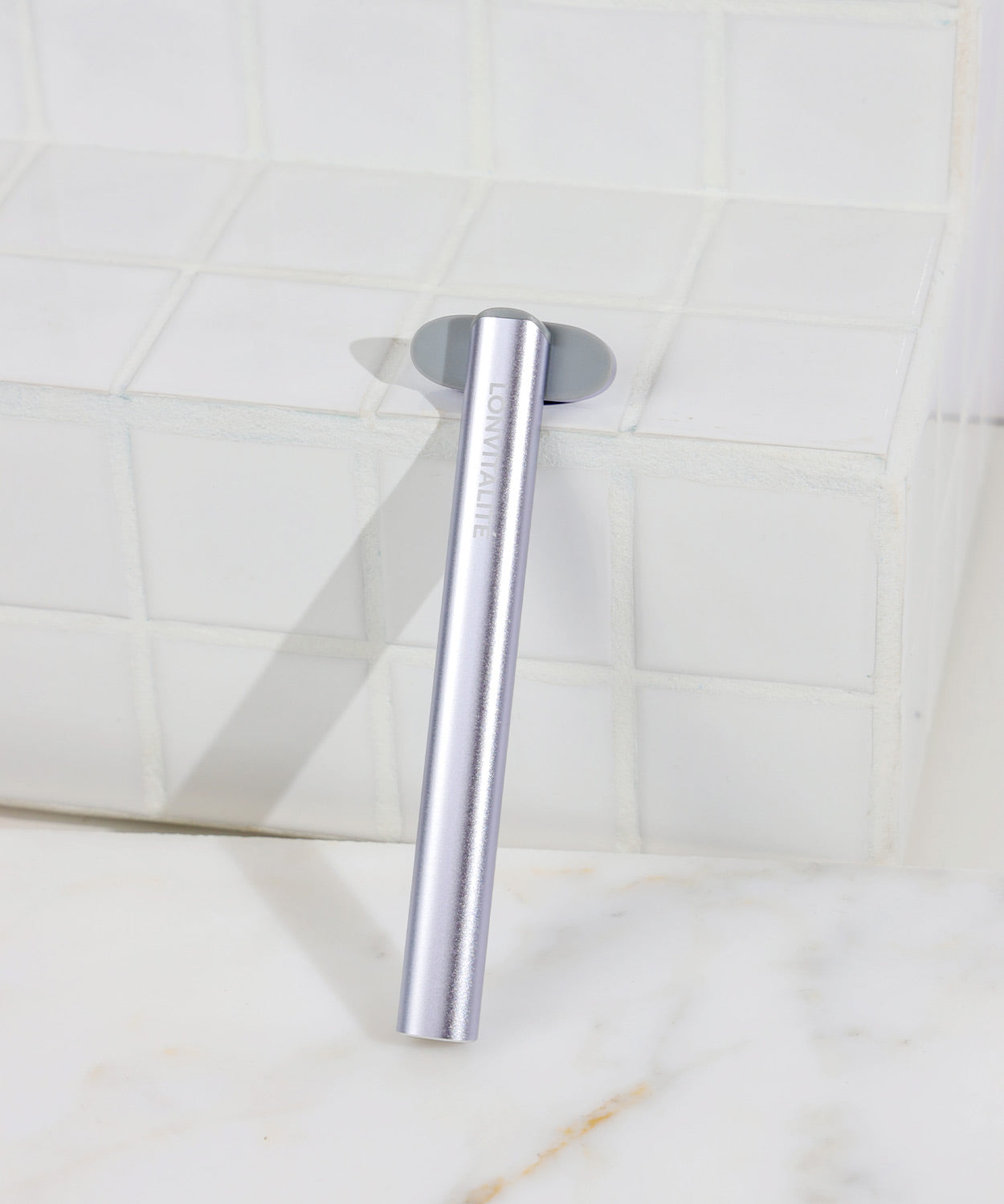 LONVITALITE PRO LED Facial Wand resting on a marble countertop